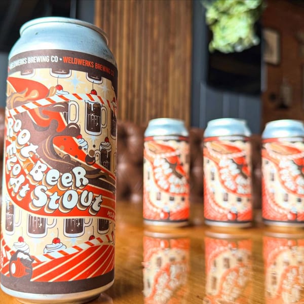 Four WeldWerks Brewing Co. "Root Beer Float At Stout" cans on a reflective wooden table.